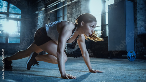 Athletic Beautiful Woman Does Running Plank as Part of Her Cross Fitness  Bodybuilding Gym Training Routine.