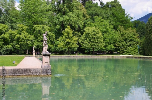 Stone sculpture and pond, in the baroque park of Hellbrunn Palace. Salzburg, Austria, Europe. photo