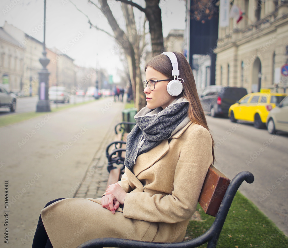 Fototapeta premium Classy woman wearing white headphones