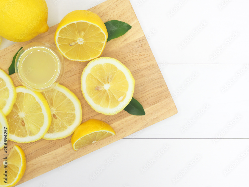 Fresh lemon slice with lemonade on white wood background