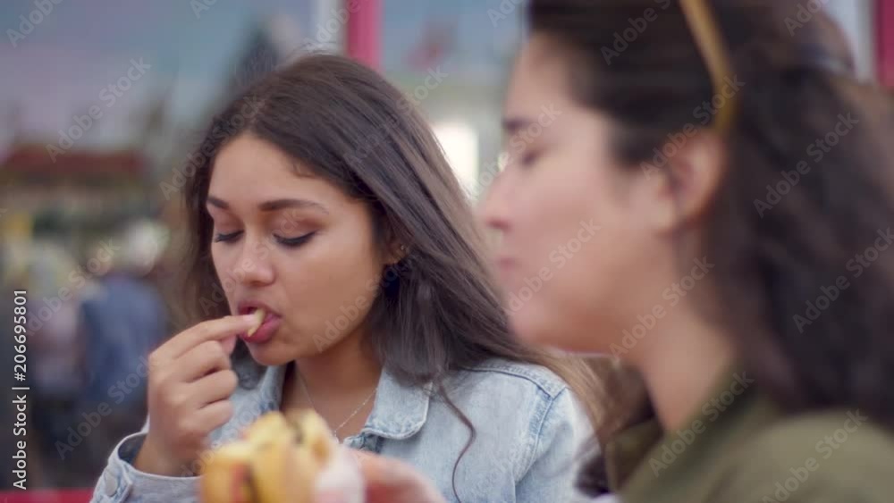 Closeup Of Friends Really Enjoying Their Burgers And Fries, On Santa Monic Pier (Shot On Red Scarlet-W Dragon In 4K, Slow Motion) Closeup Of Friends Really Enjoying Their Burgers And Fries, On Santa Monic Pier (Shot On Red Scarlet-W Dragon In 4K, Slow Motion)