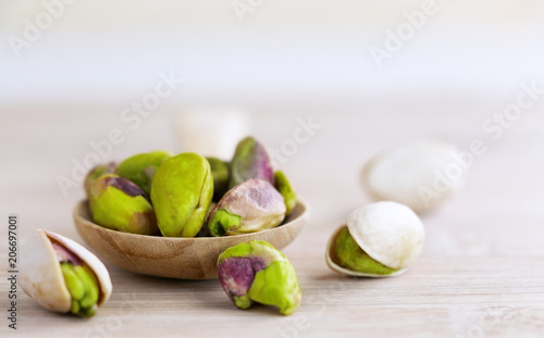 Wallpaper Mural Pistachios in the wooden spoon on the wood table. Torontodigital.ca