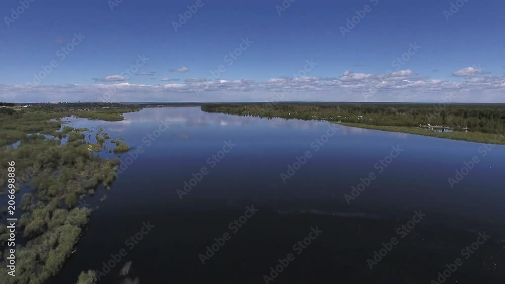 Rise above River in Spring. The video is taken from the copter, flying over a large river in the spring during the flood. The trees have recently appeared on fresh leaves. Rise above River in Spring. The video is taken from the copter, flying over a large river in the spring during the flood. The trees have recently appeared on fresh leaves.