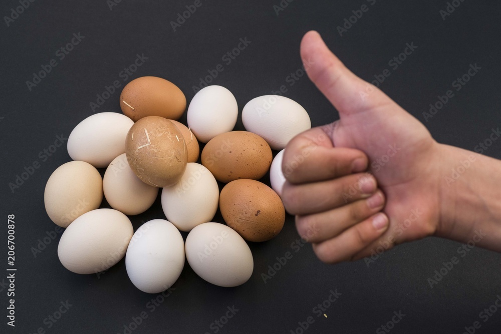 On the black ground organic village eggs and ok sign,
On the black ground organic village eggs and ok sign,