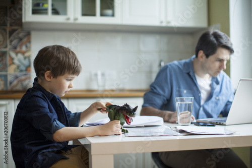 Bilde på lerret Little son disturbing working freelancer father