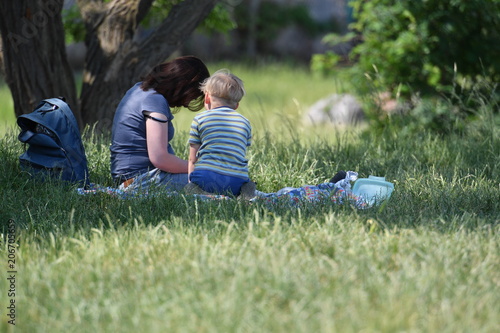 Wall Mural A young mother and her child on a meadow in the Berlin-Tempelhof area