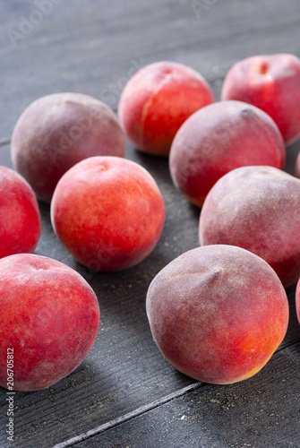 ripe homegrown peaches on black wooden table