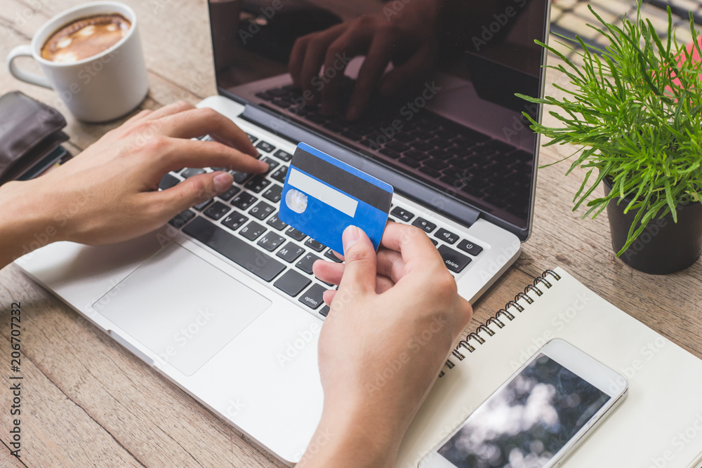 Man holding credit card and using laptop. Online shopping Man holding credit card and using laptop. Online shopping