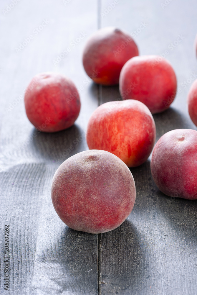 ripe homegrown peaches on black wooden table ripe homegrown peaches on black wooden table