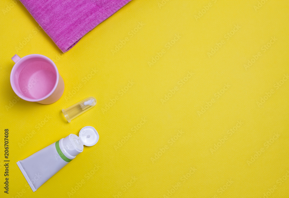 Toothpaste and brush for the youngest children, yellow background Toothpaste and brush for the youngest children, yellow background