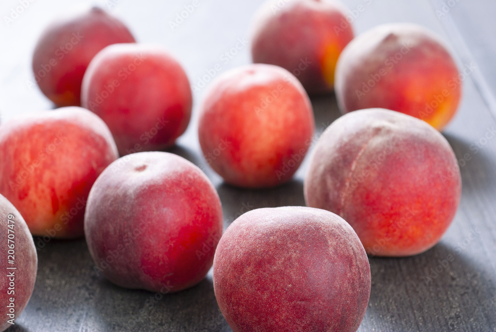 ripe homegrown peaches on black wooden table ripe homegrown peaches on black wooden table