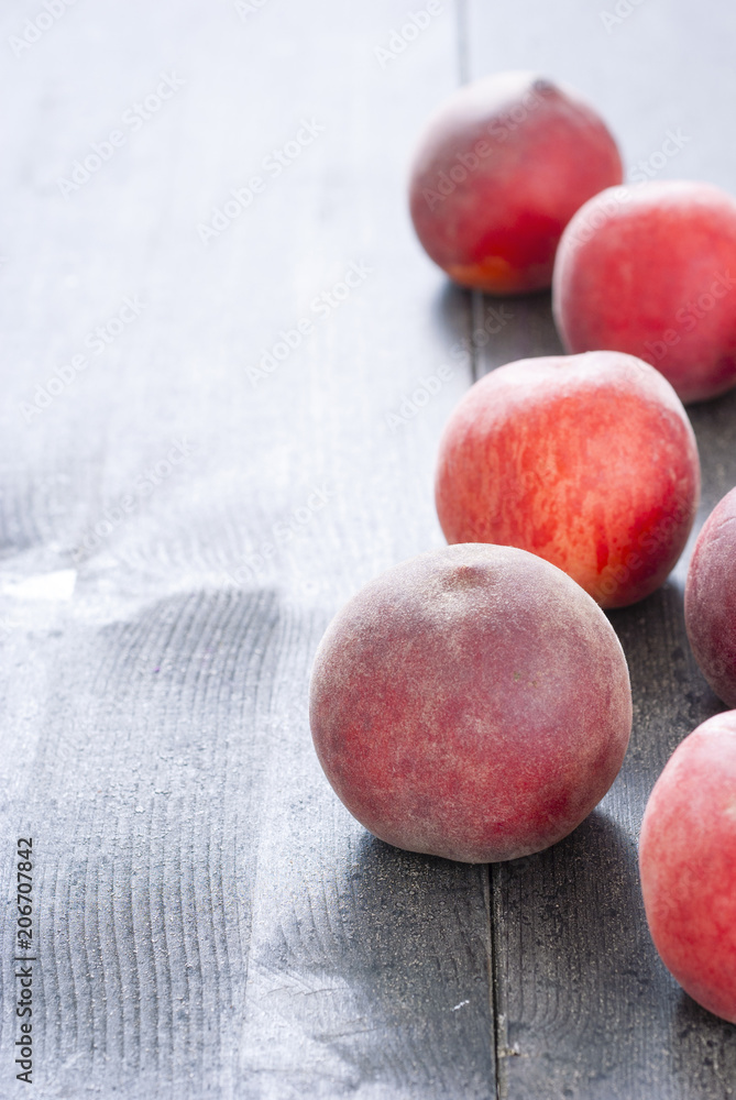 ripe homegrown peaches on black wooden table ripe homegrown peaches on black wooden table