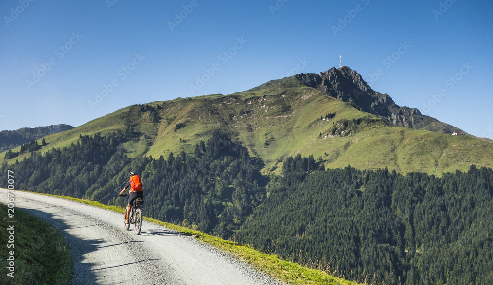 senior woman underway on her electrical mountain bike to the summit of Kitzbuehler Horn, Tirol,Austria