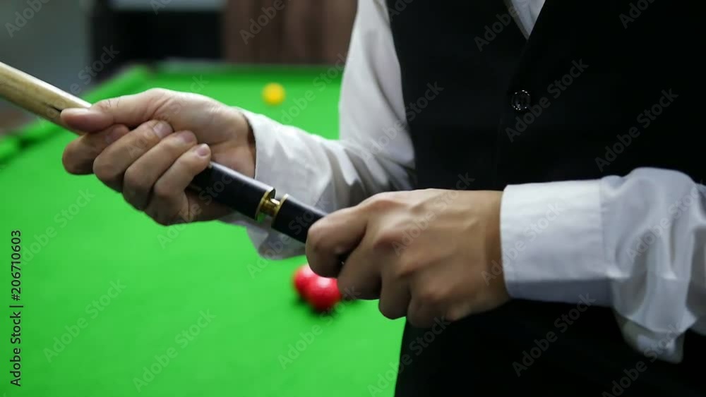Slow motion of snooker player using two piece cues stick - people play snooker in real match competition concept Slow motion of snooker player using two piece cues stick - people play snooker in real match competition concept