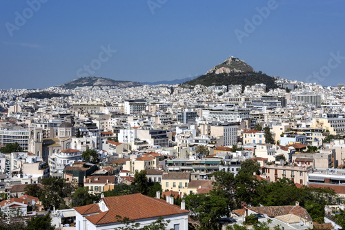 Greece, Athens, Lycabettos: Sunset panorama view of famous majestic Mount Lycabettus hill in the city center of the Greek capital with skyline horizon and blue sky in the background. 