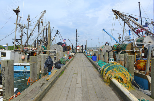 maritime scene with commercial fishing boats near dock before sailing into the ocean