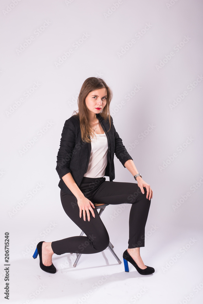 beautiful sexual businesswoman sitting on chair on white background. beautiful sexual businesswoman sitting on chair on white background.