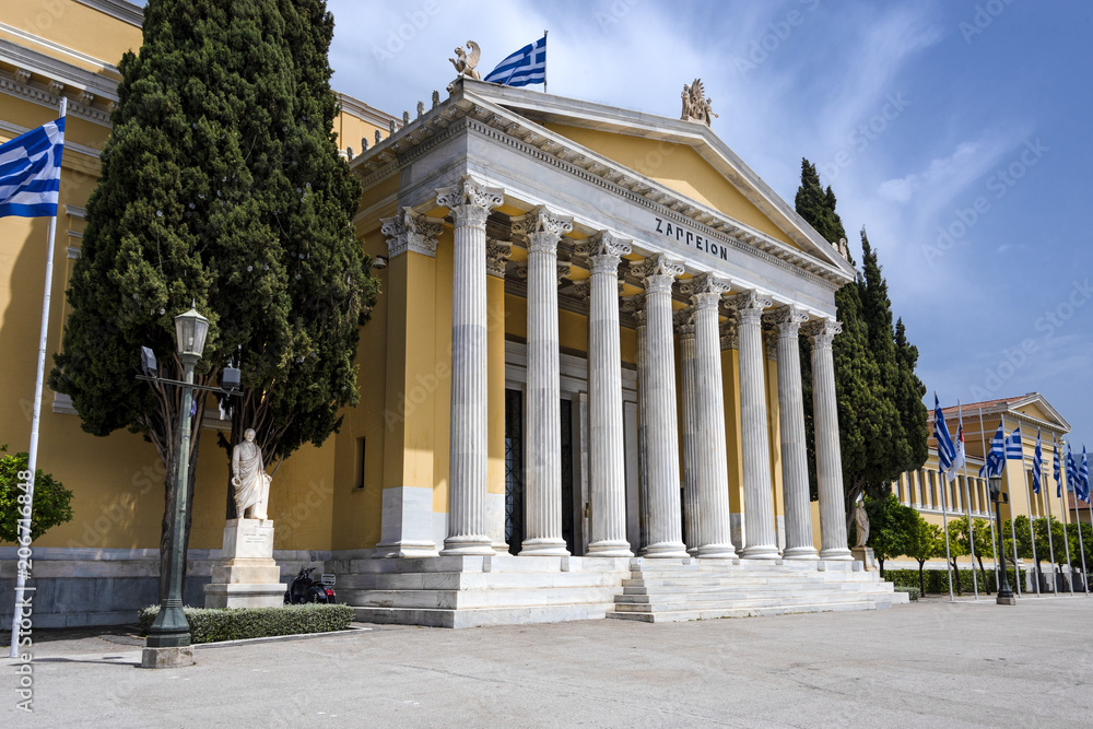 Greece, Athens: Front view of famous Zappeion building in the city center of the Greek capital and part of National Gardens with blue sky in the background - concept architecture travel history