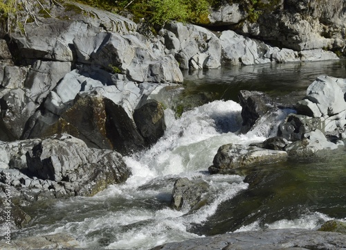 closeup of a riverbed with white water rapids and rocks  Kennedy River British Columbia Canada 