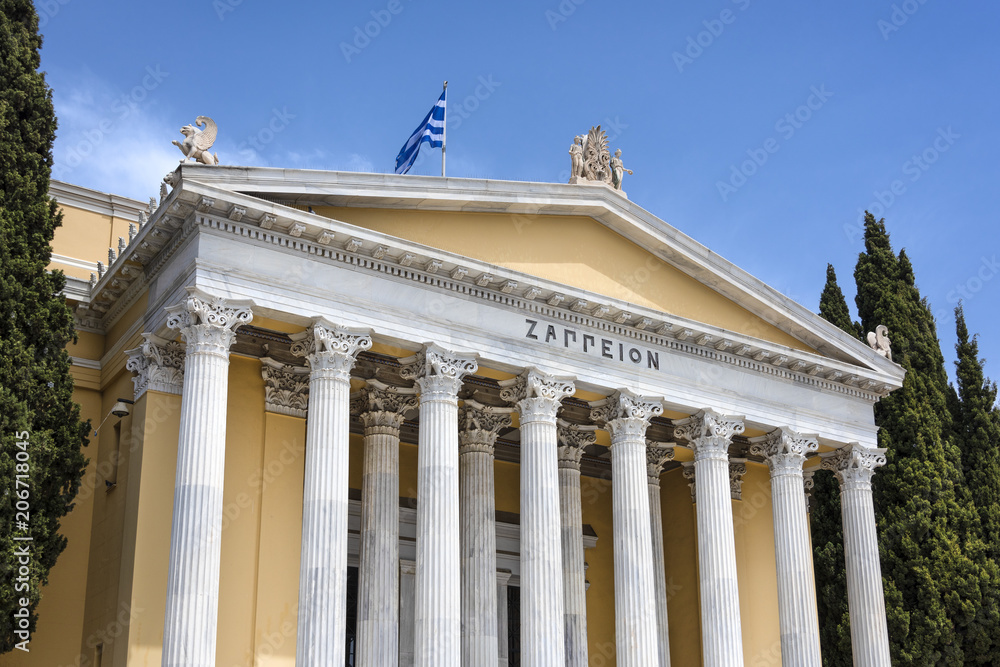 Greece, Athens: Front view of famous Zappeion building in the city center of the Greek capital and part of National Gardens with blue sky in the background - concept architecture travel history