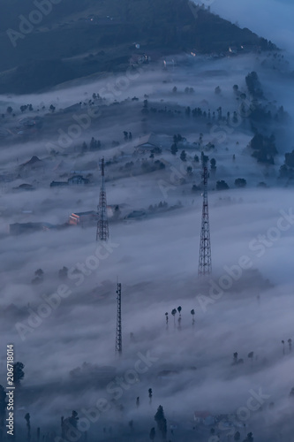 Fog Flood through the cliff village in Bromo ,Indonesia / One of the most stunning phenomena scene © Nut