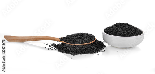 Black sesame in a wooden spoon isolated on white