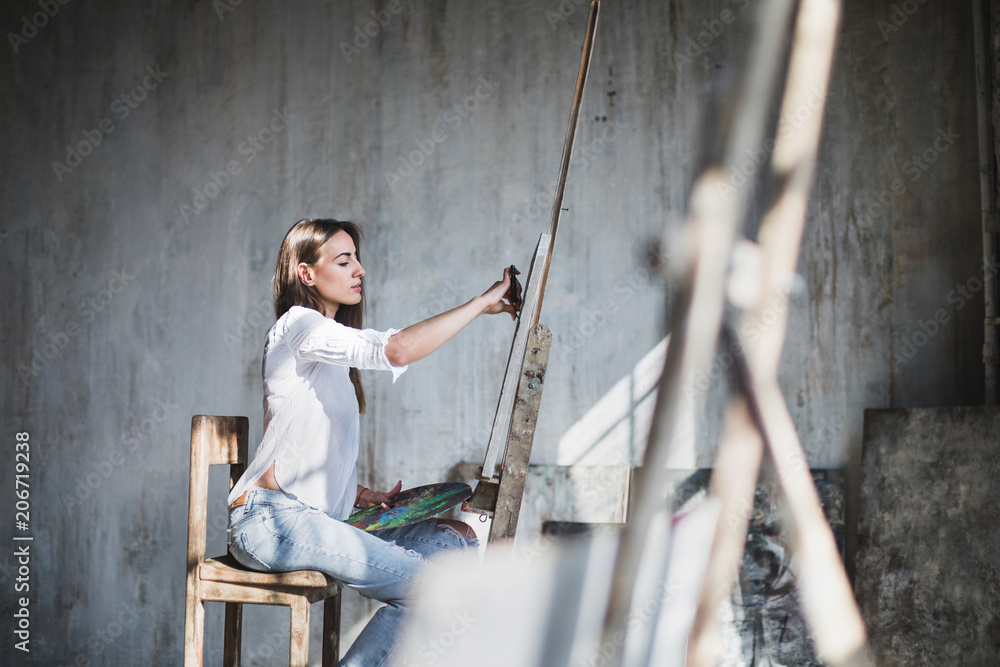 Modern artist painting oilpaints in studio. Modern artist painting oilpaints in studio.