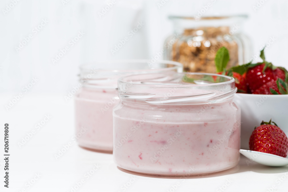 strawberry yogurt, oats granola and fresh berries on white background strawberry yogurt, oats granola and fresh berries on white background