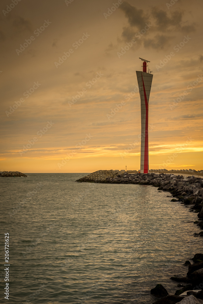 Radar tower in the port of Oostende (Belgium), with sunset sky in the background. The tower was designed by the architect Eggermont