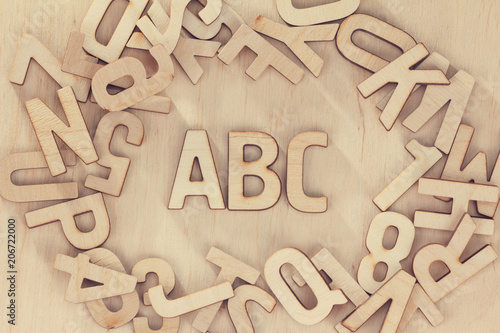 Alphabet Wooden letters set symbols, wood background. ABC education concept.