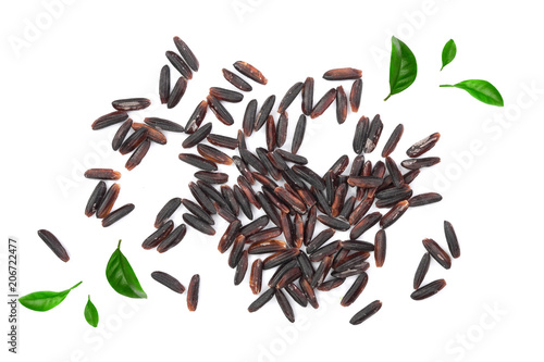 Black wild rice isolated on white background decorated with green leaves. Top view. Flat lay