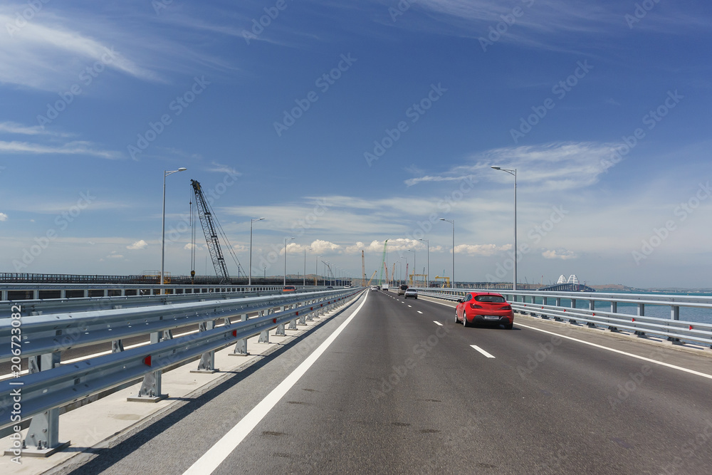 Cars go on the Crimean bridge towards the city of Kerch. Sunny day