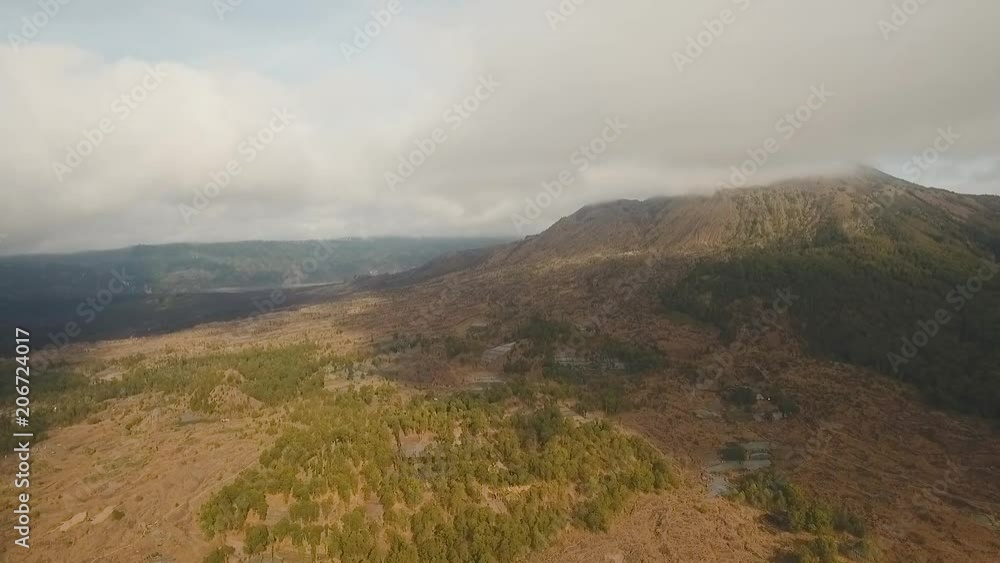 Volcano, mountains, sky with clouds. Aerial view of Mount Batur Volcano in Kintamani. Bali volcano, also referred to as Kintamani is popular sightseeing destination in Bali. Travel concept. Aerial