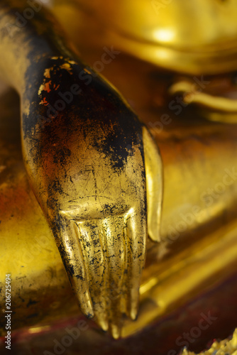 Hand character of golden image of buddha in the attitude of subduing Mara in Wat Pho temple, Bangkok, Thailand photo