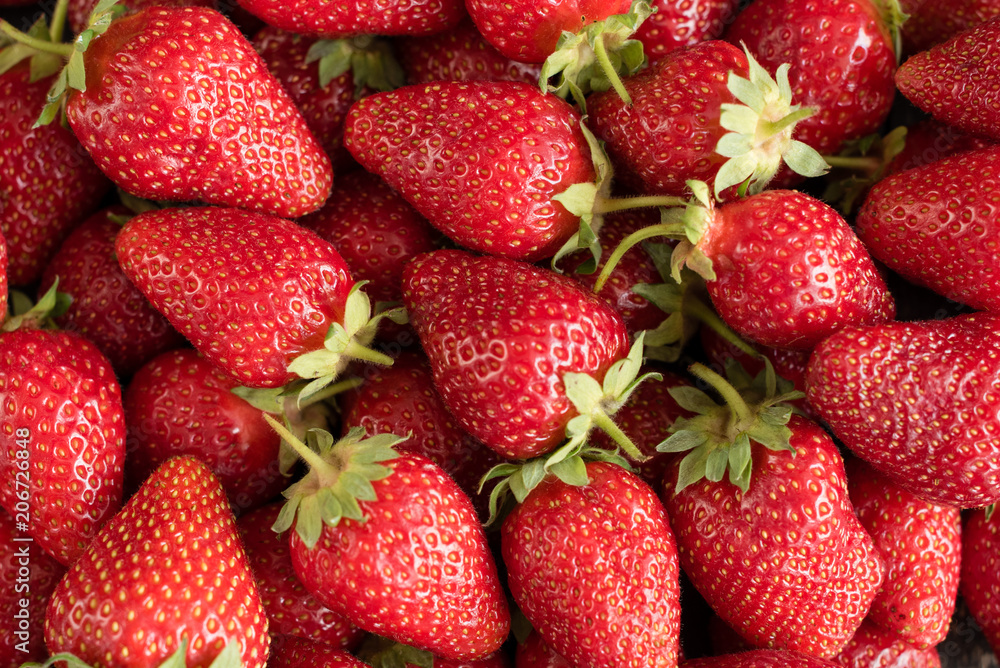 Tasty strawberry on a wooden table. It can be used as a background Tasty strawberry on a wooden table. It can be used as a background