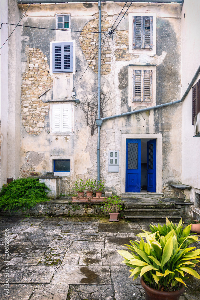 Facade with entrance door and windows of an old house in the city of Motovun on Istria in Croatia, Europe.