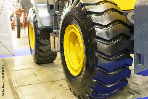 Close up of tractor tire, selective focus. Modern Tractor Close-Up. photo