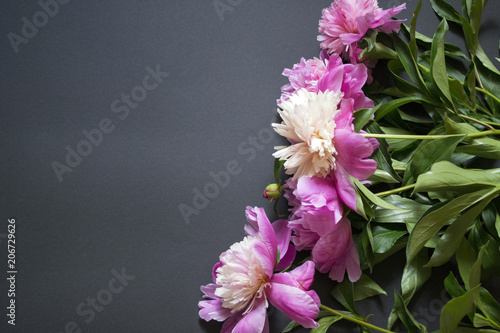 Pink and white peonies bouquet on a black background