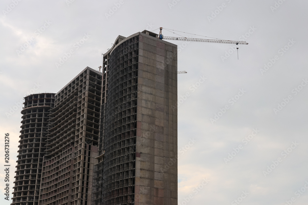 Building crane and house under construction Building crane and house under construction