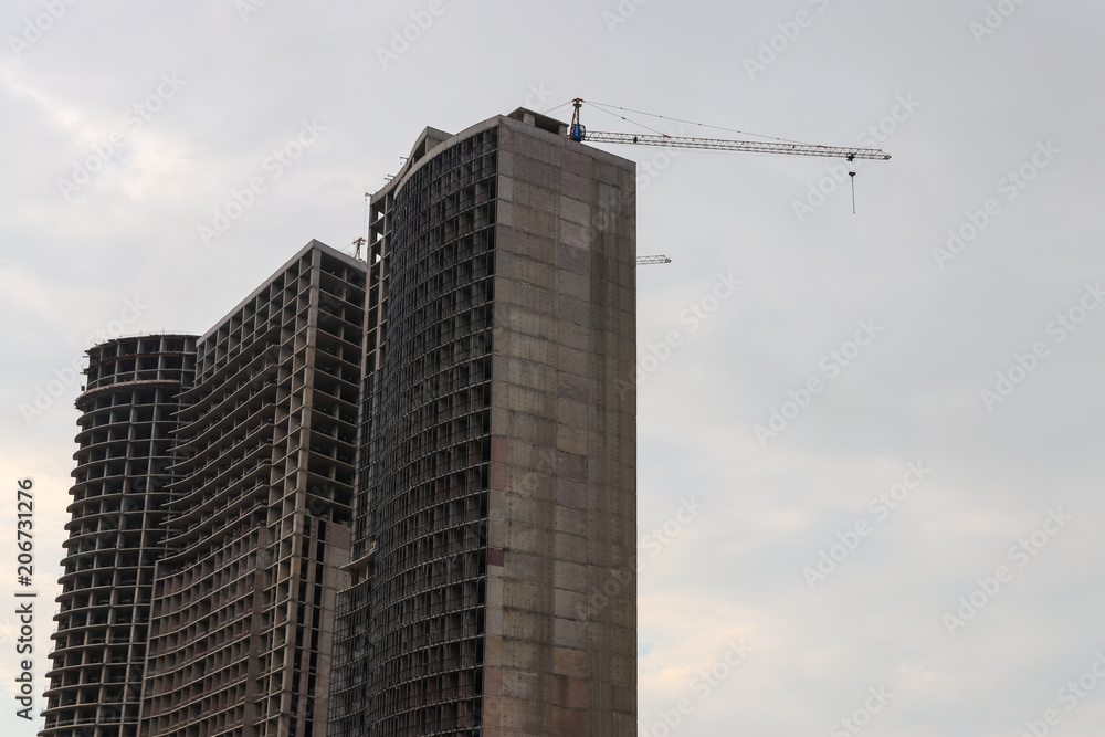 Building crane and house under construction