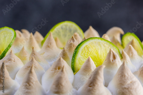 Lime meringue cake with slices of lime - detail view