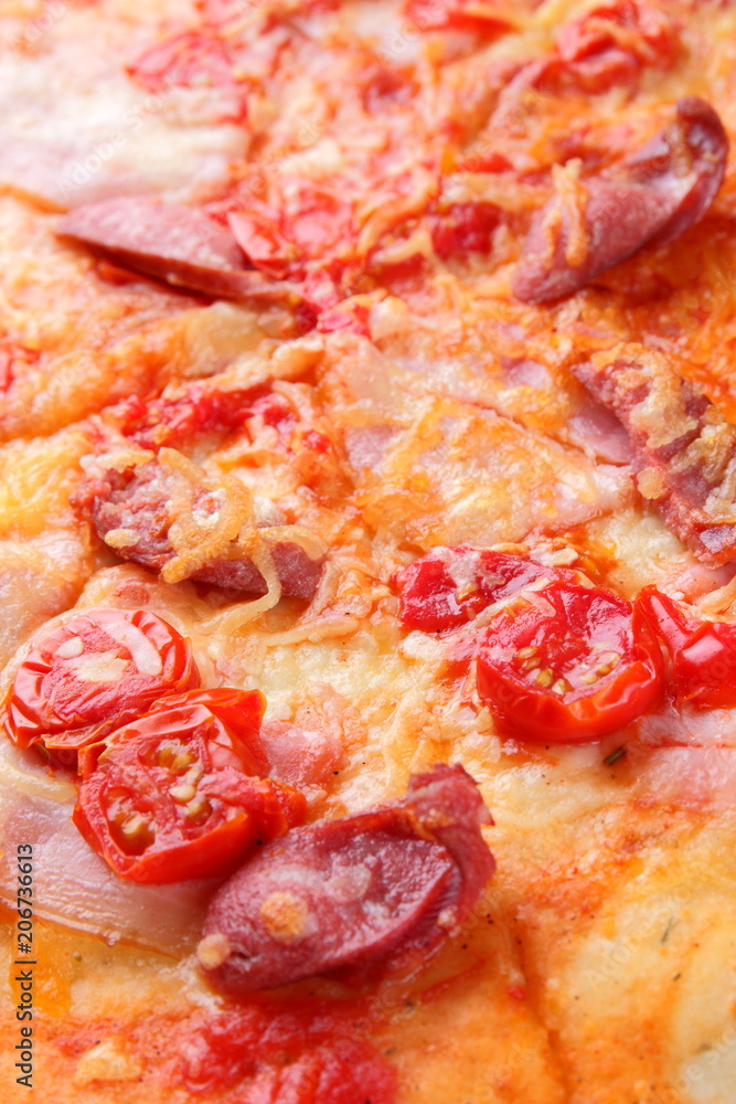 Pizza close-up, Italian pizza with bacon, tomatoes, sausages and cheese, appetizing pastry top view, baked cheese cake with meat, delicious lunch, designer's preparation Pizza close-up, Italian pizza with bacon, tomatoes, sausages and cheese, appetizing pastry top view, baked cheese cake with meat, delicious lunch, designer's preparation