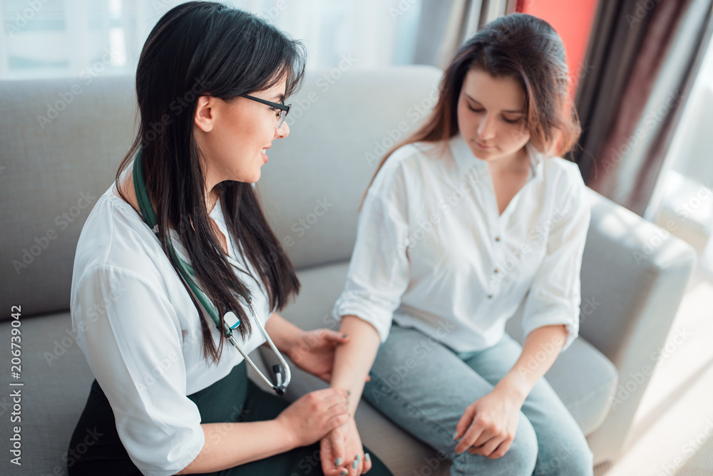 Family doctor check heart rate of a young mother Family doctor check heart rate of a young mother