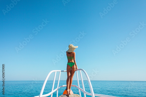 girl in bikini sails across the sea to paradise