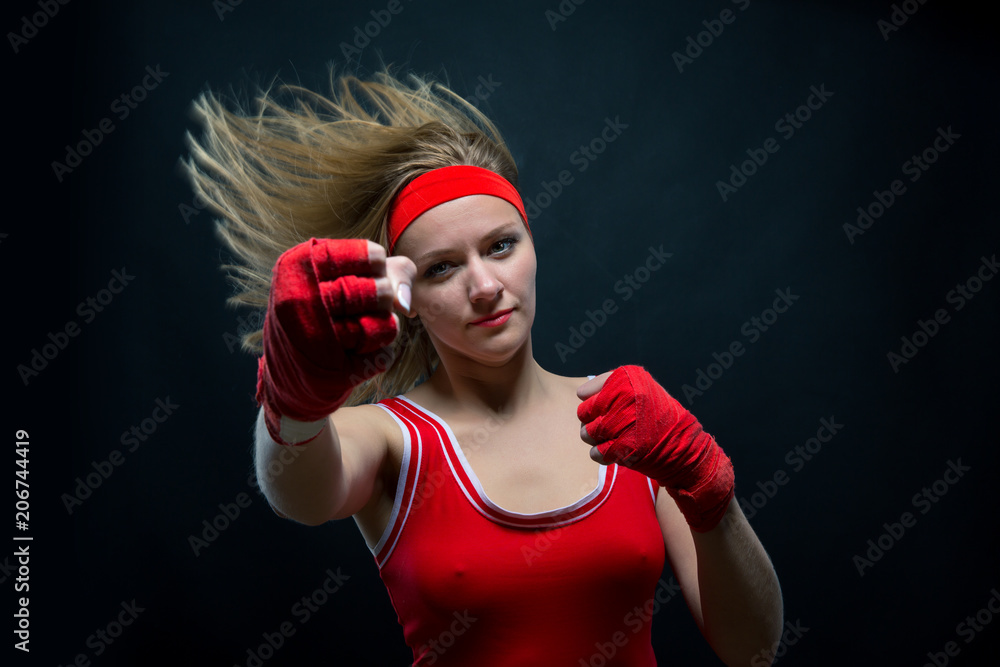 Female boxer in red boxing bandages and sportswear Female boxer in red boxing bandages and sportswear