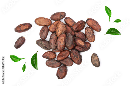 unpeeled cocoa bean decorated with green leaves isolated on white background close-up top view