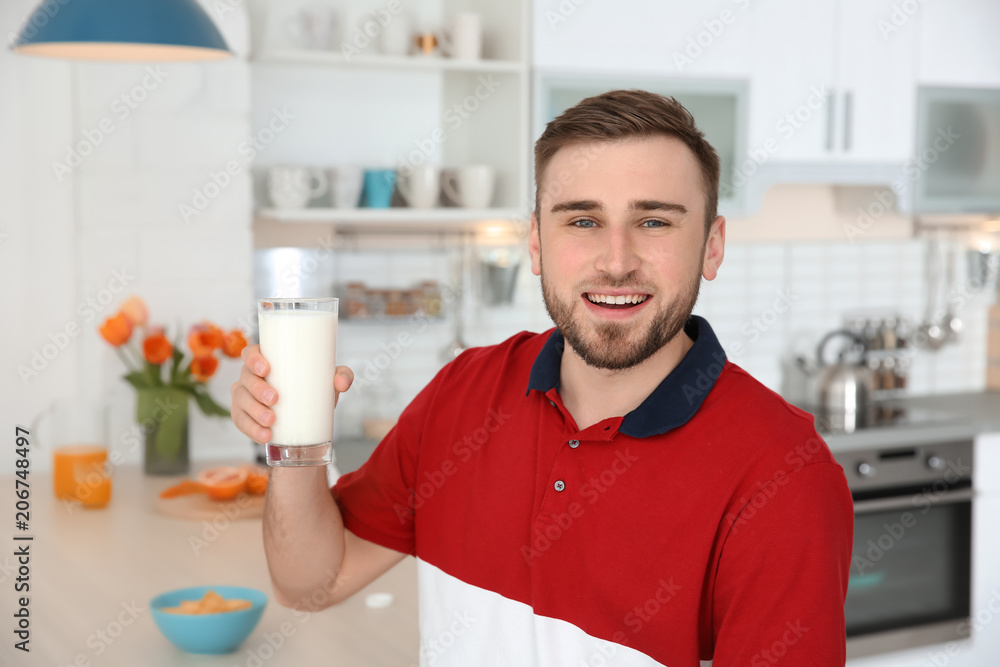 Young man with glass of tasty milk at home Young man with glass of tasty milk at home