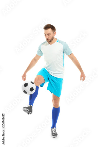 Young man playing football on white background © New Africa