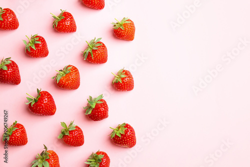 Flat lay composition with with tasty ripe strawberries on color background