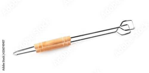 New barbecue tongs with wooden handle on white background photo